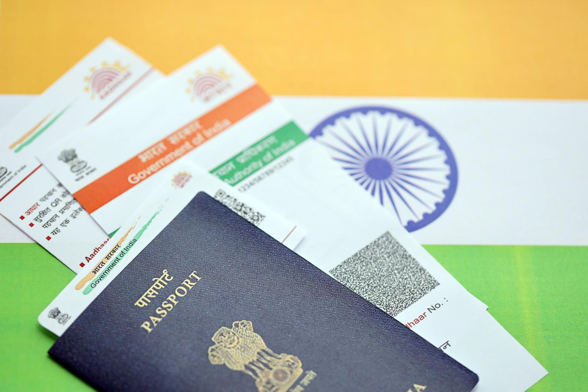Identity documents including passport, Aadhaar, and PAN cards